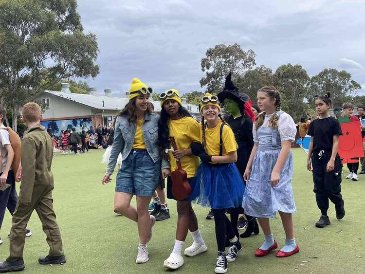 several students outside in book parade costume