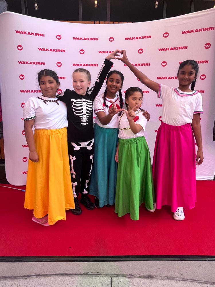 5 students in wakakirri dance costumes
