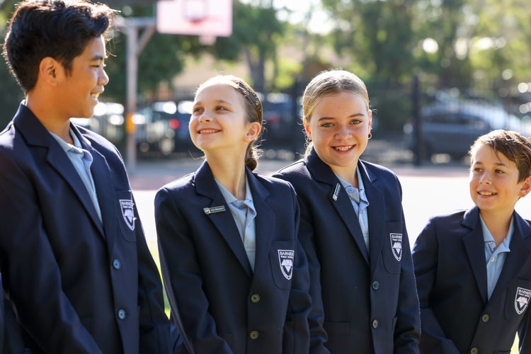 4 senior students on school blazer standing outside